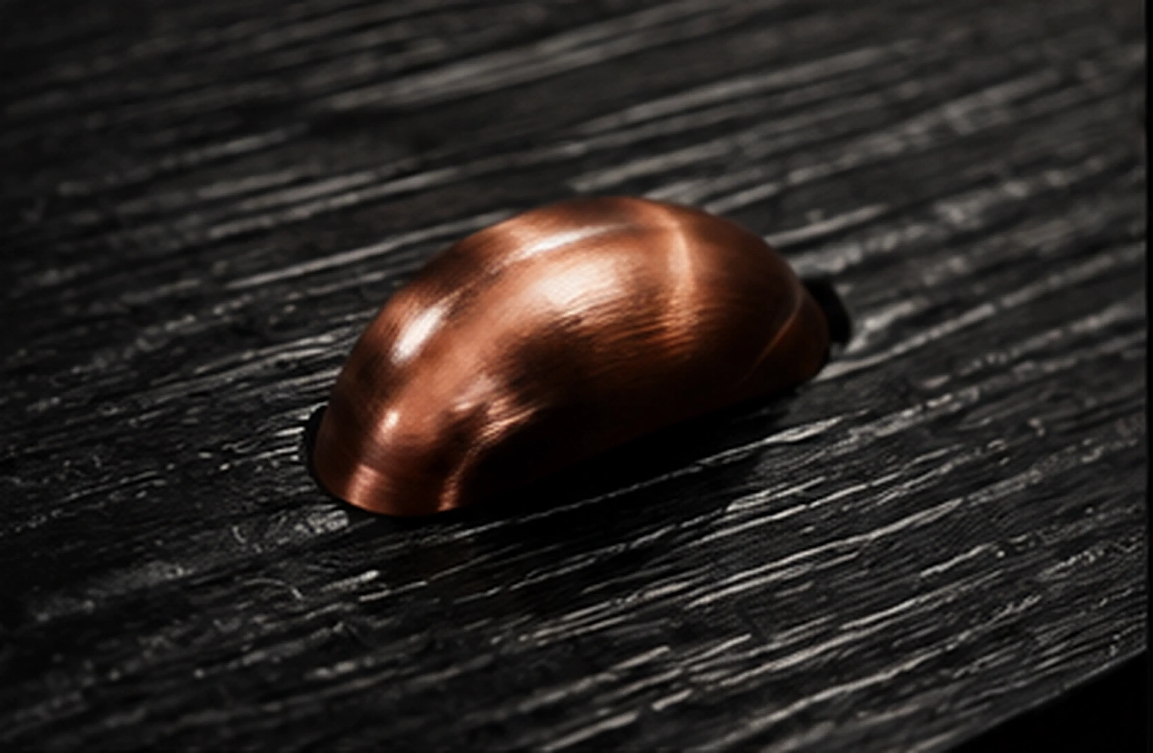 Macro of a single thread-wrapped stud set into the black leather