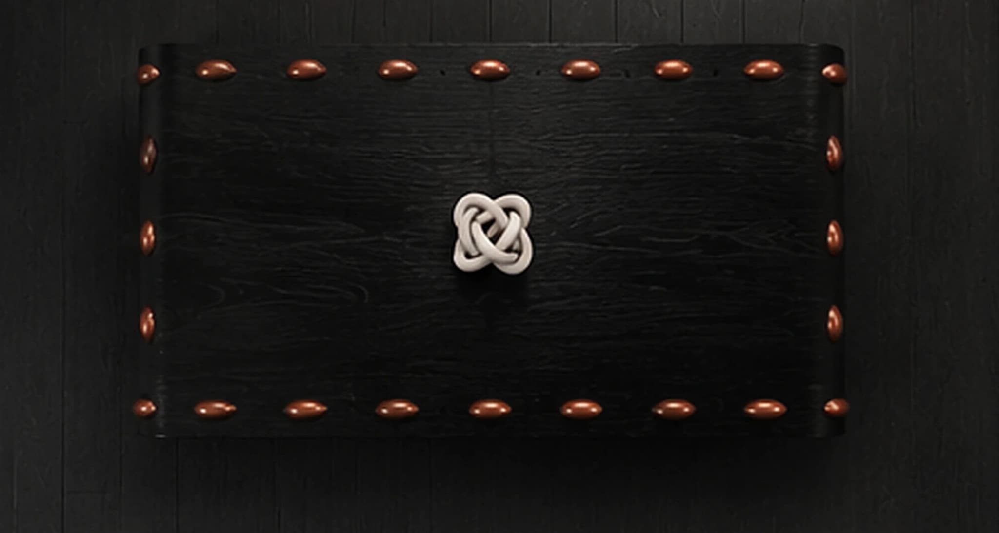 The Leather Stud Coffee Table seen directly from above, the full stud perimeter and the knot